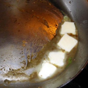 Add pieces of butter to reduced wine